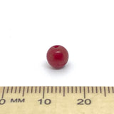 Red bead on a ruler for size reference
