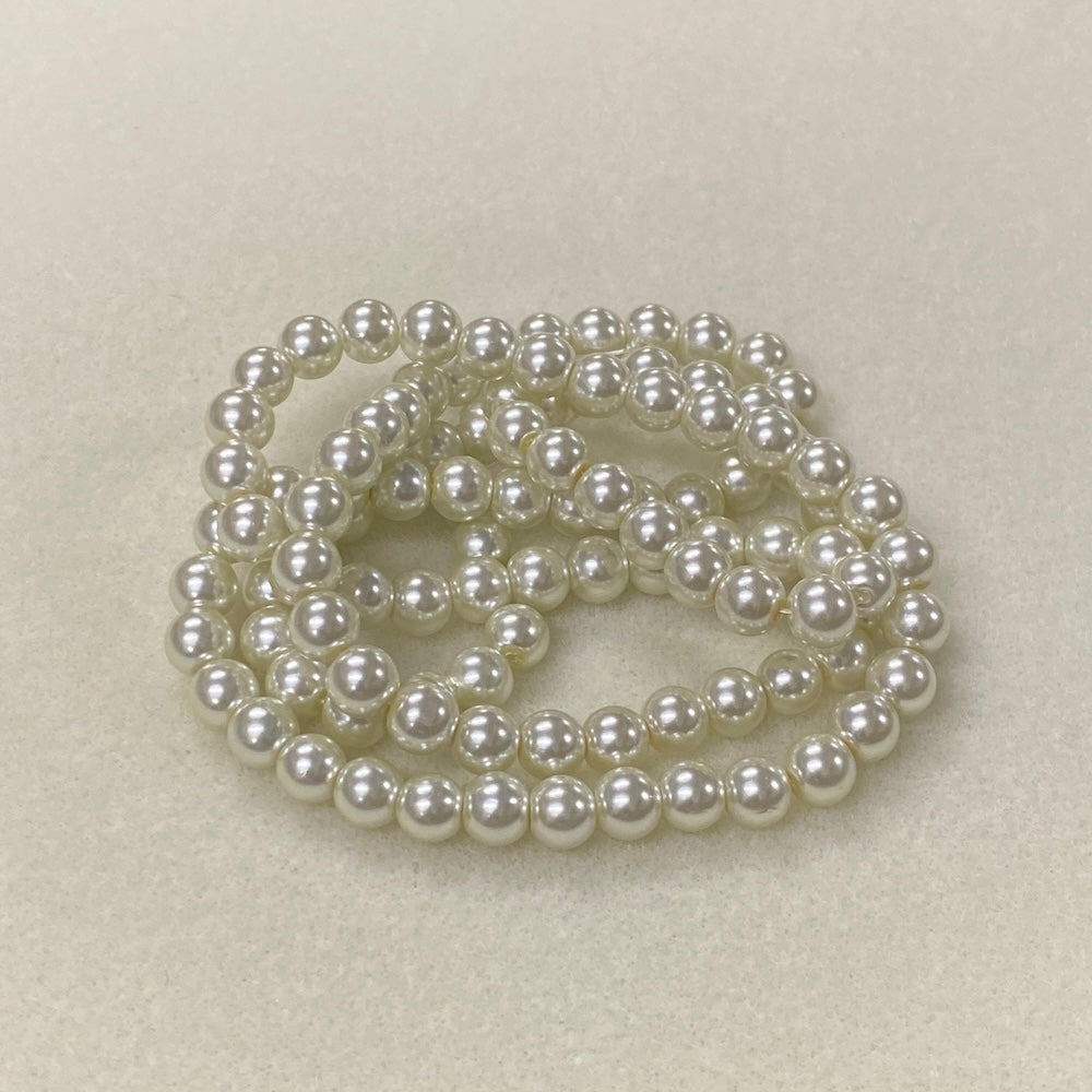 Pearl necklace on a light beige background