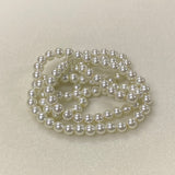 Pearl necklace on a light beige background