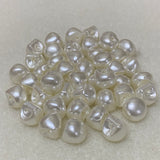 Collection of white pearl buttons on a light gray background