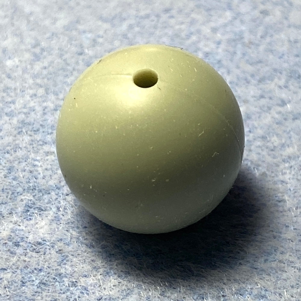light green silicone bead on a textured gray background