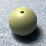 light green silicone bead on a textured gray background