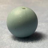 light blue silicone bead on a textured gray background