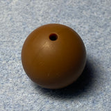 brown silicone bead on a textured gray background