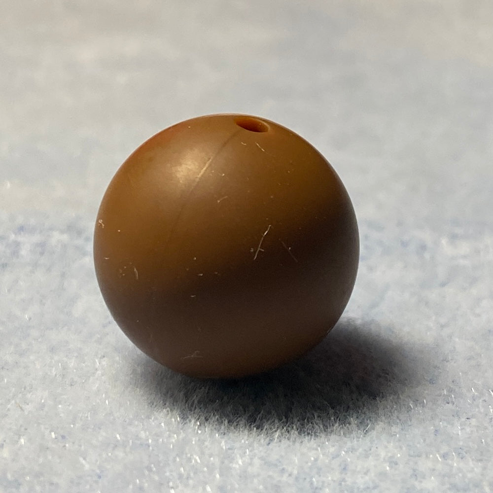 brown silicone bead on a textured gray background