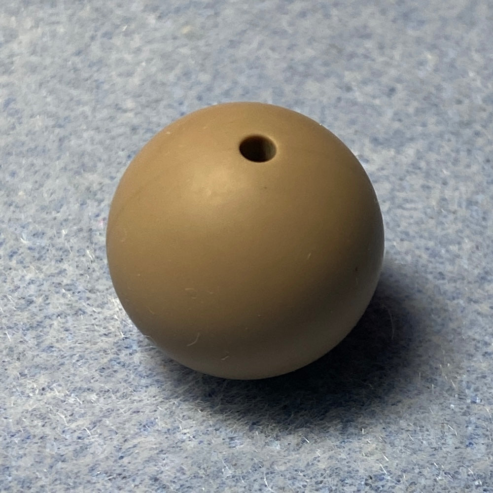 beige silicone bead on a textured gray background