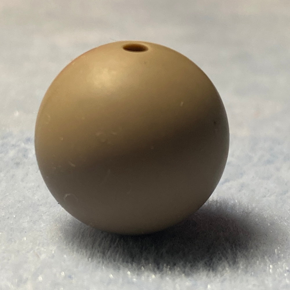 beige silicone bead on a textured gray background