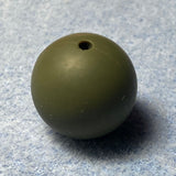 Green silicone bead on a textured gray background