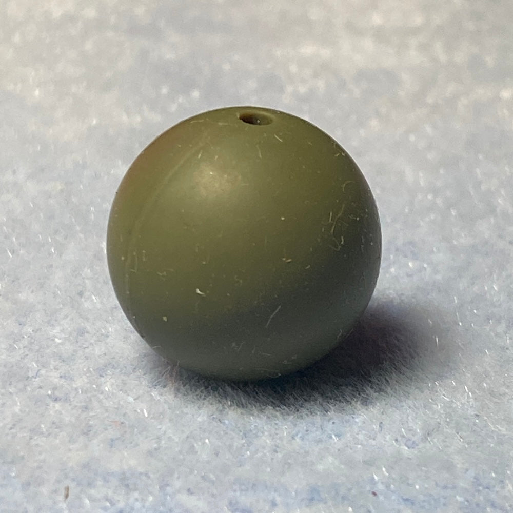 Green silicone bead on a textured gray background