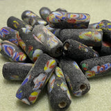 Colorful marbled beads on a beige surface