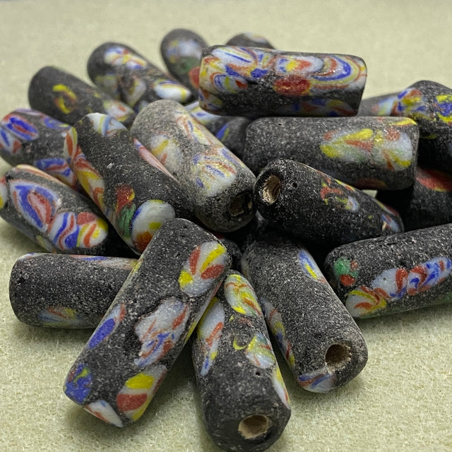 Colorful marbled beads on a beige surface