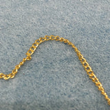 Gold chain on a gray textured background