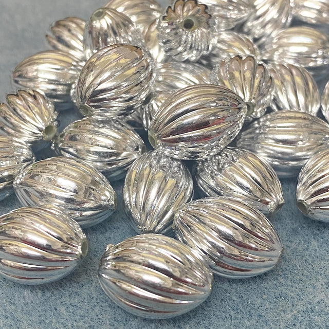 Silver metallic beads on a gray surface