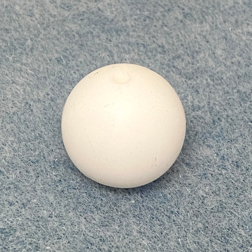 white round silicone bead on a textured gray background