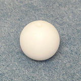 white round silicone bead on a textured gray background