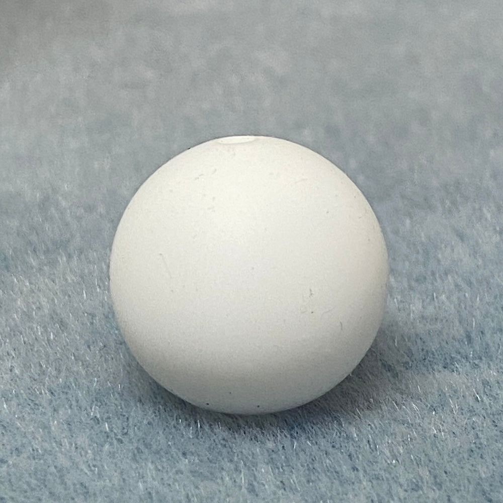 white round silicone bead on a textured gray background