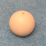 blush pink round silicone bead on a textured gray background