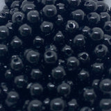 Close-up of black beads with a dark background