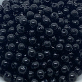 Close-up of black beads on a white background