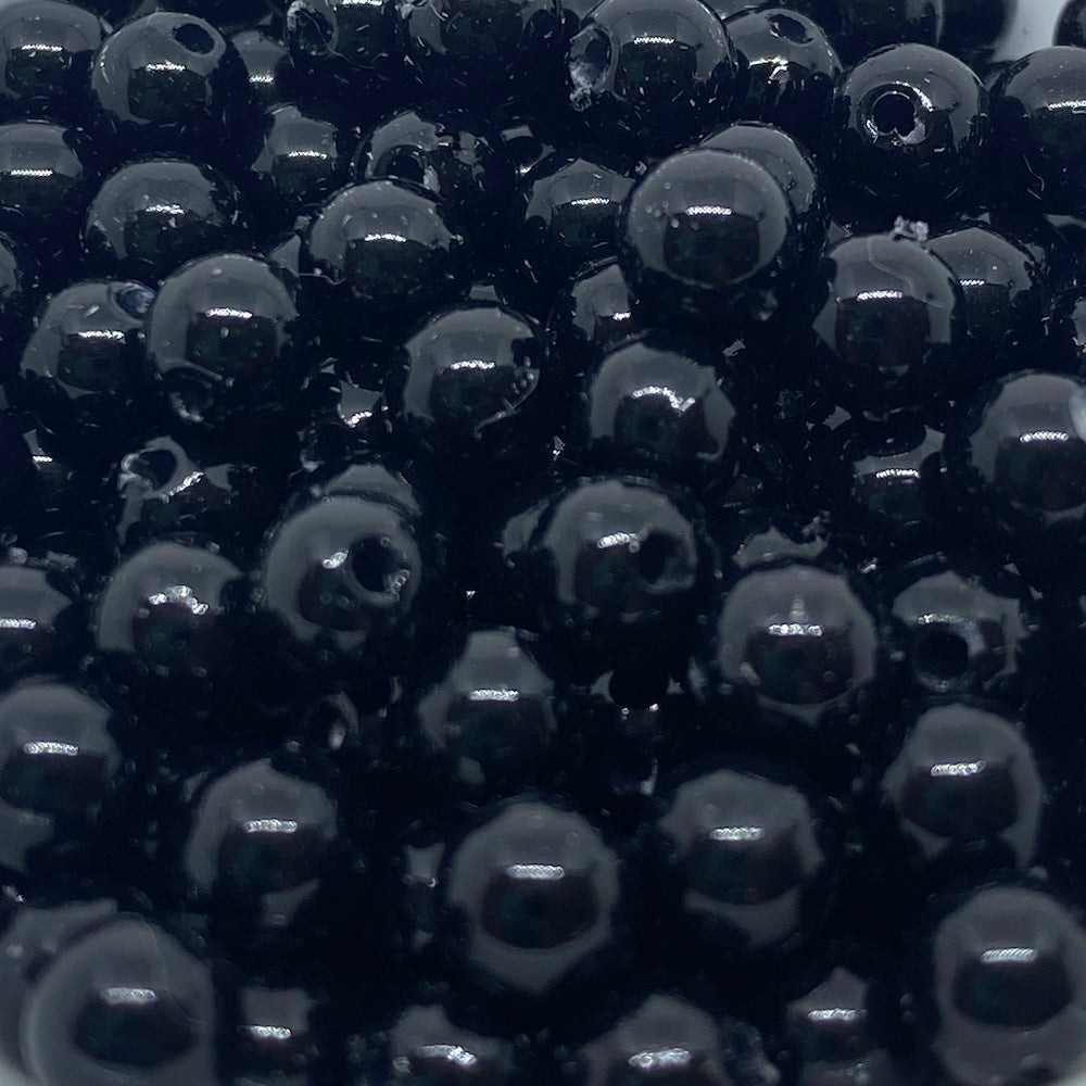 Close-up of black beads with a glossy finish