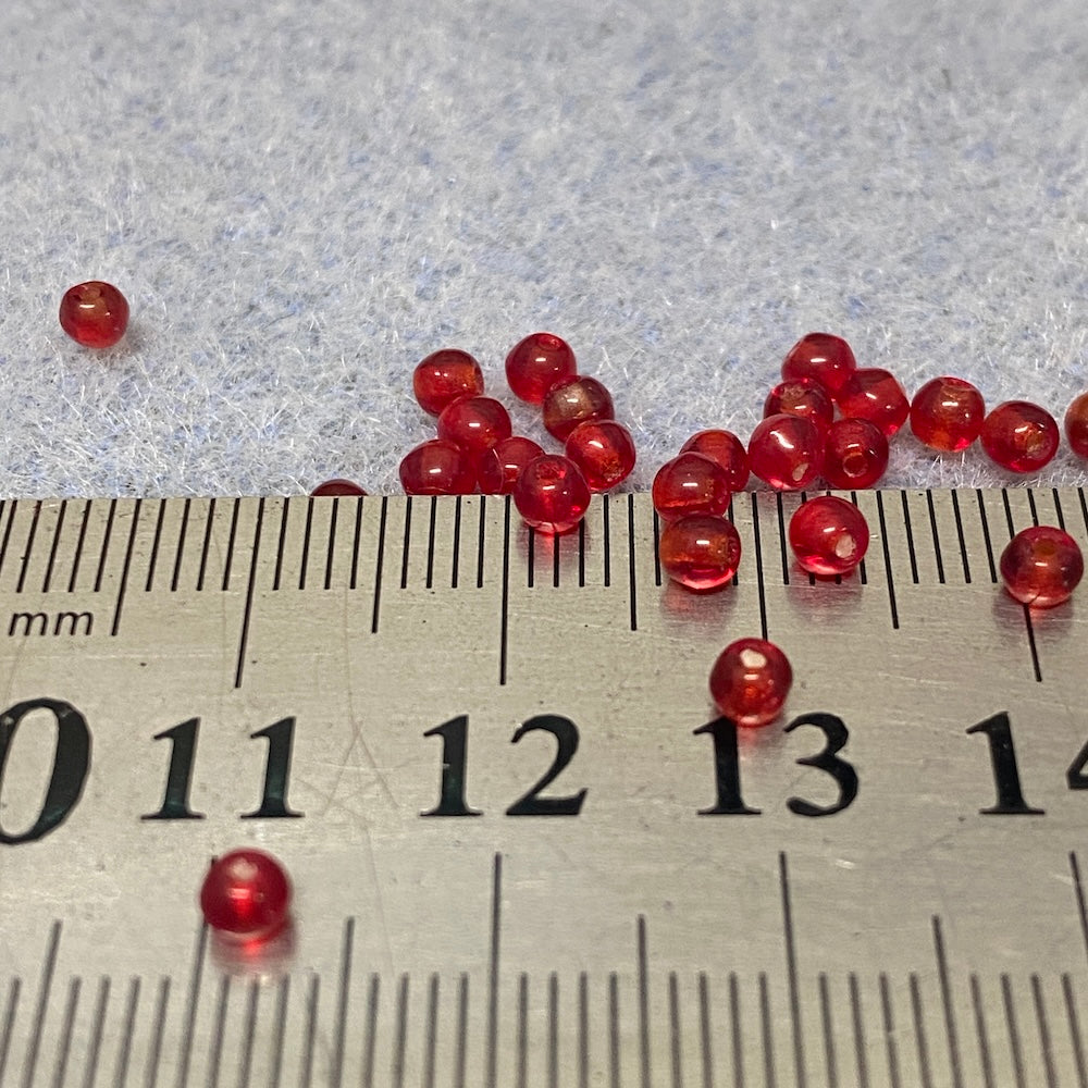 Red beads on a ruler for size reference