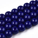 Close-up of dark blue beads on a white background