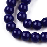 Close-up of a string of dark blue beads on a white background