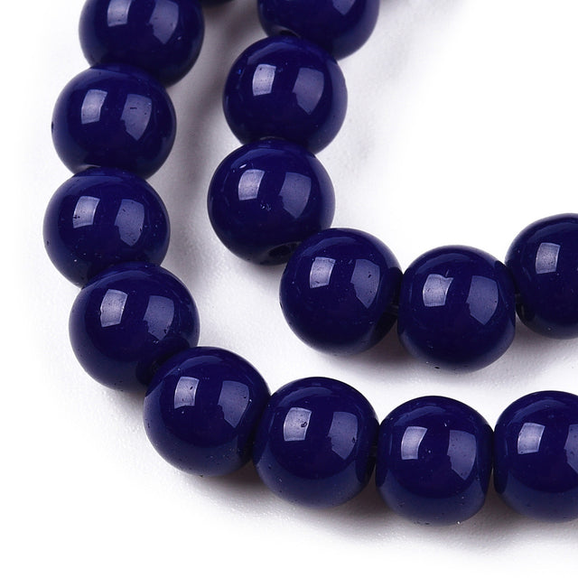 Close-up of a string of dark blue beads on a white background
