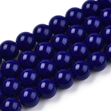 Close-up of dark blue beads on a white background