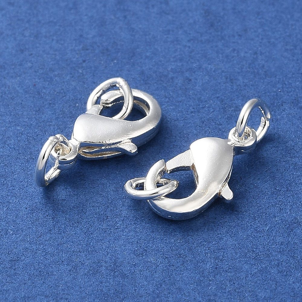 2 anti tarnish plated jewelry clasps with rings for the purpose of making a closure on a necklace or bracelet on a blue background