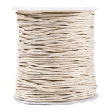Spool of beige cord on a white background