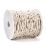 Spool of beige cord on a white background