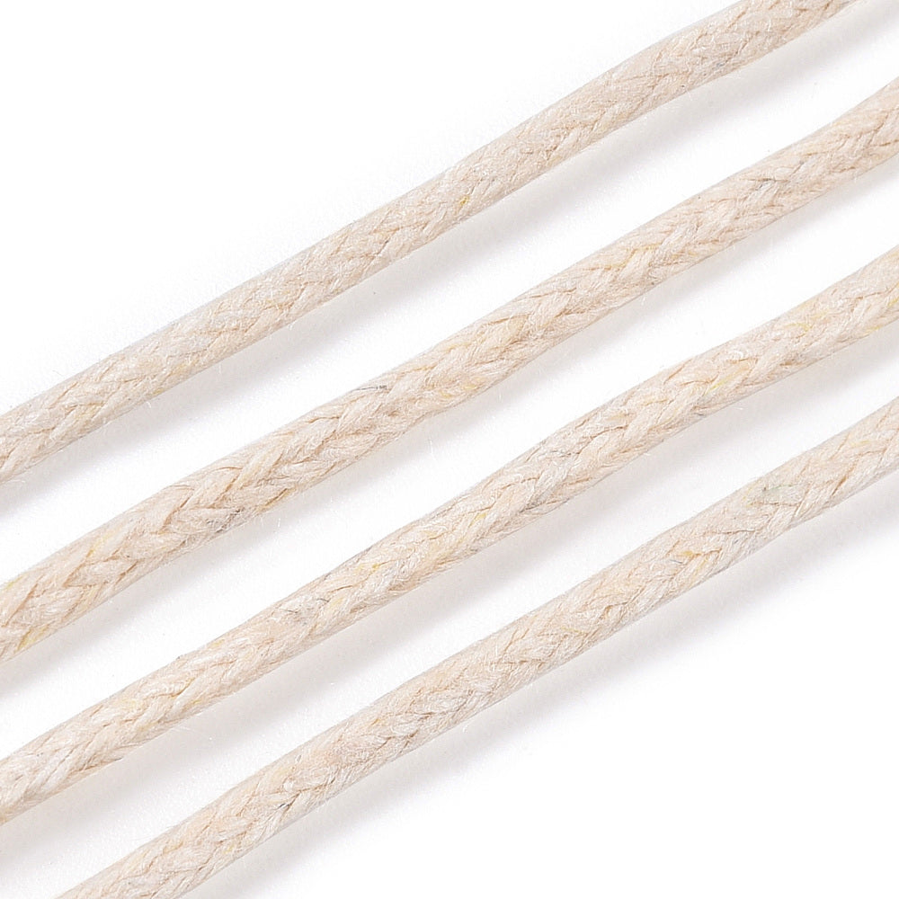 Close-up of beige braided cord on a white background
