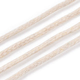 Close-up of beige braided cord on a white background