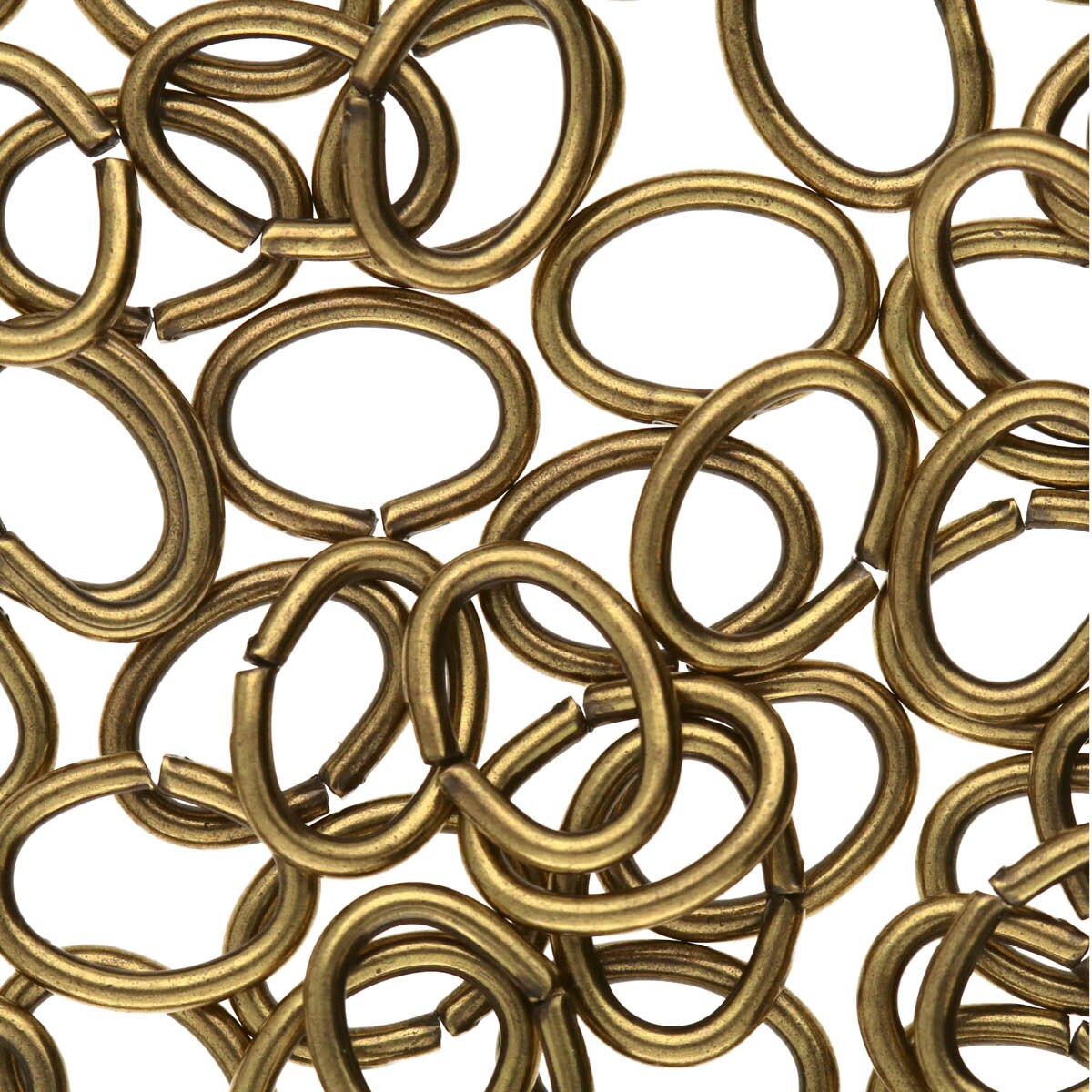 Collection of bronze metal rings on a white background