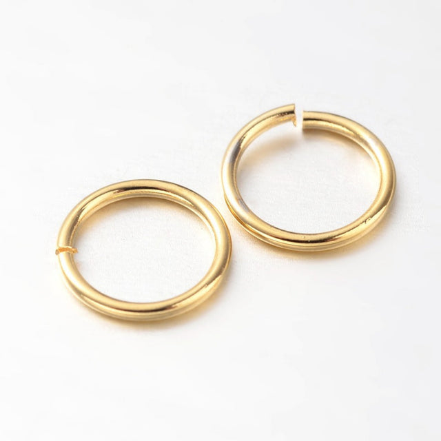 two small metal joining jump rings to connect jewelry and craft items with anti tarnish surface on a white background