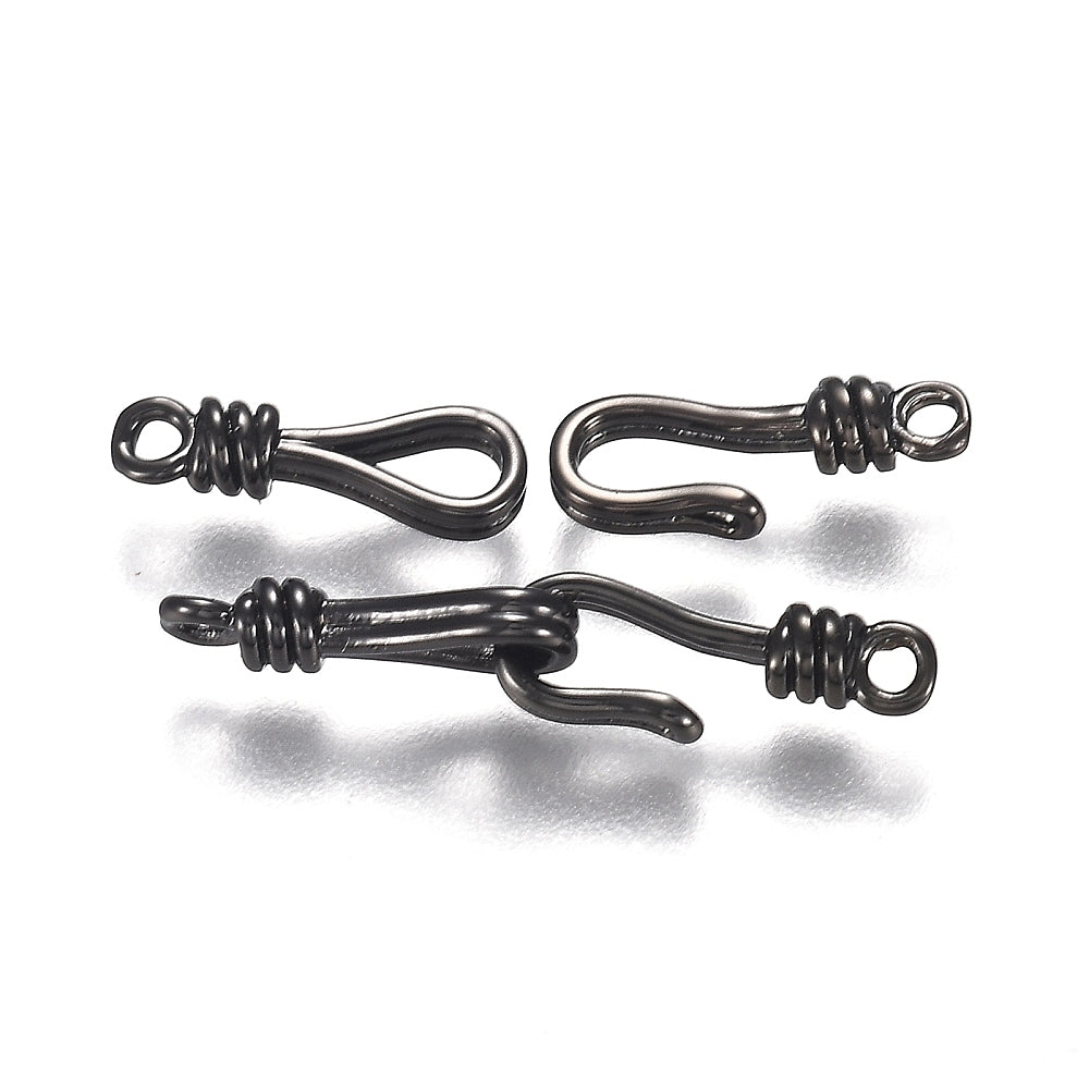 Three black metal hooks on a white background