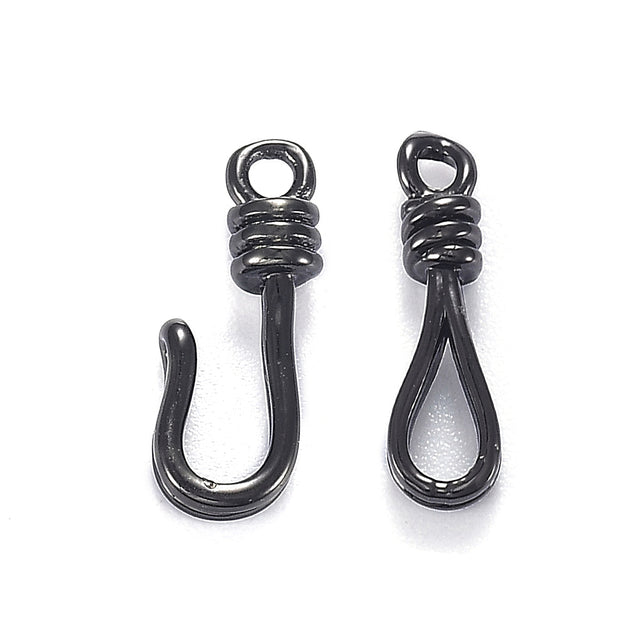 Two black metal hook clasp on a white background