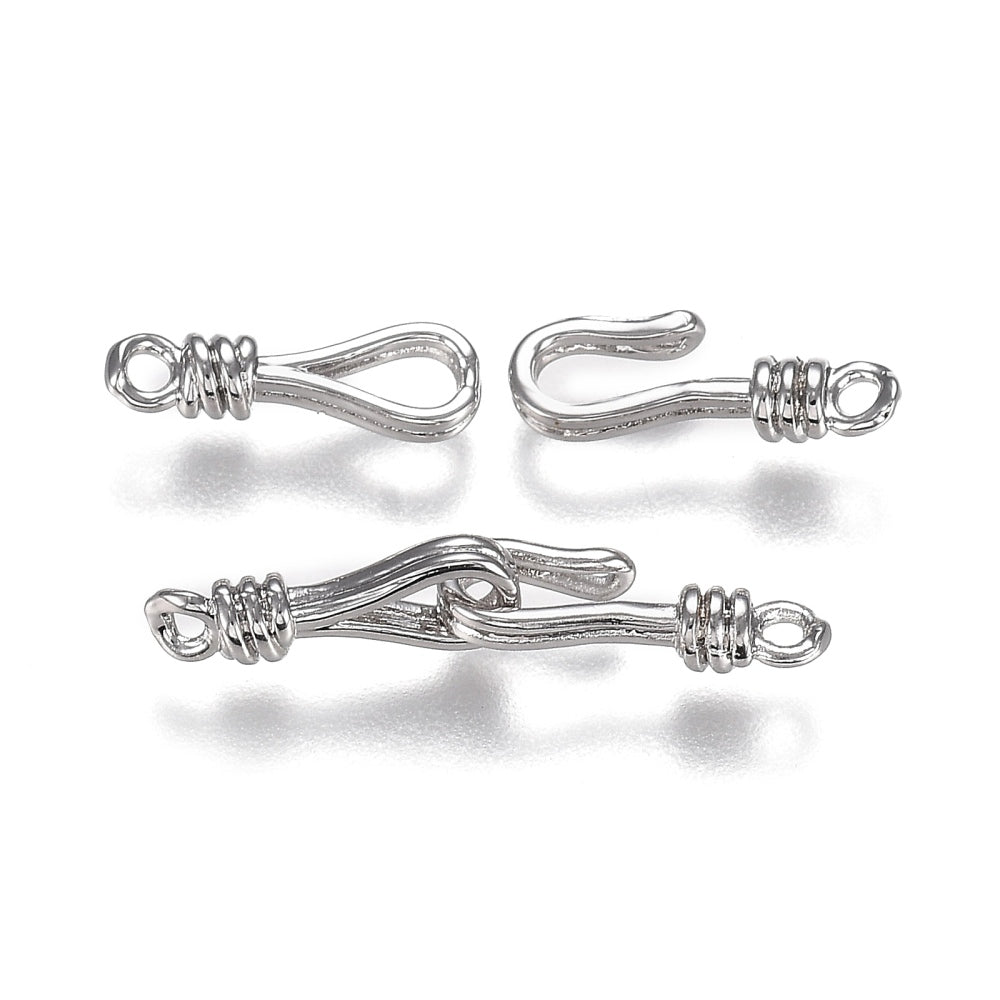 Two silver metal clasps on a white background