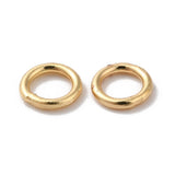 Pair of gold closed soldered jump rings on a white background