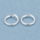 Two silver  connector rings on a light blue background