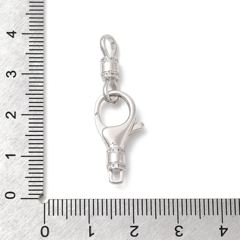 Silver clasp with measurement scale on a white background