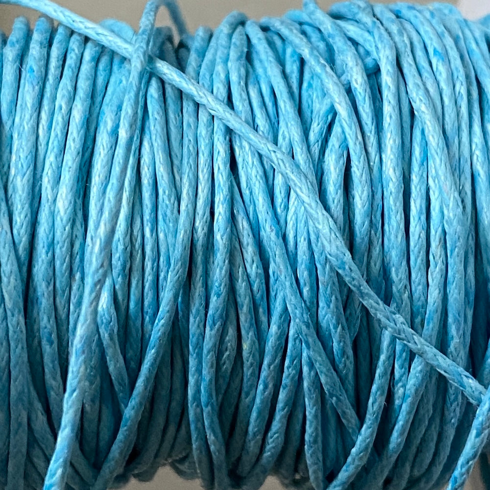 Close-up of light blue wax cotton strands