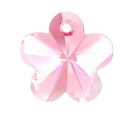 Pink flower shape crystal bead on a white background