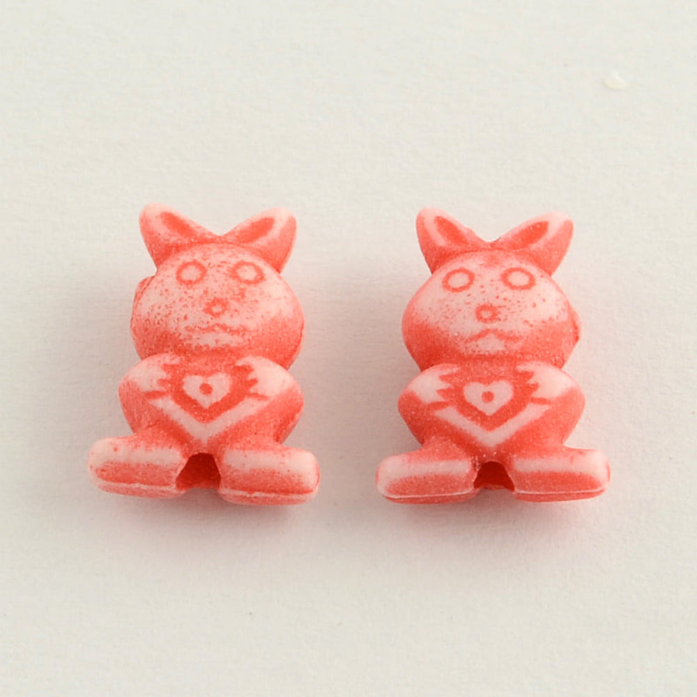2 Colorful rabbit-shaped beads on a white background