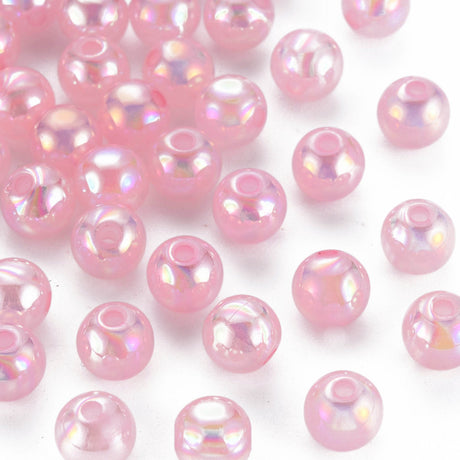 A collection of round pink acrylic beads with a slight metallic sheen, intended for crafting and jewelry making.