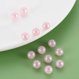 Pink pearl beads on a white plate and green background