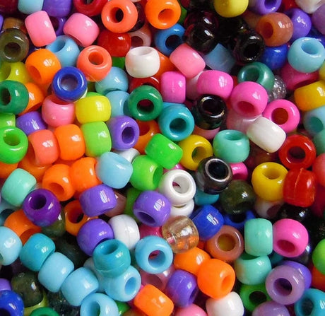 Assorted colorful plastic beads in various colors.