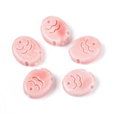 Five pink ceramic fish beads with wave designs on a white background