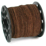 Spool of brown leather lace cord on a white background